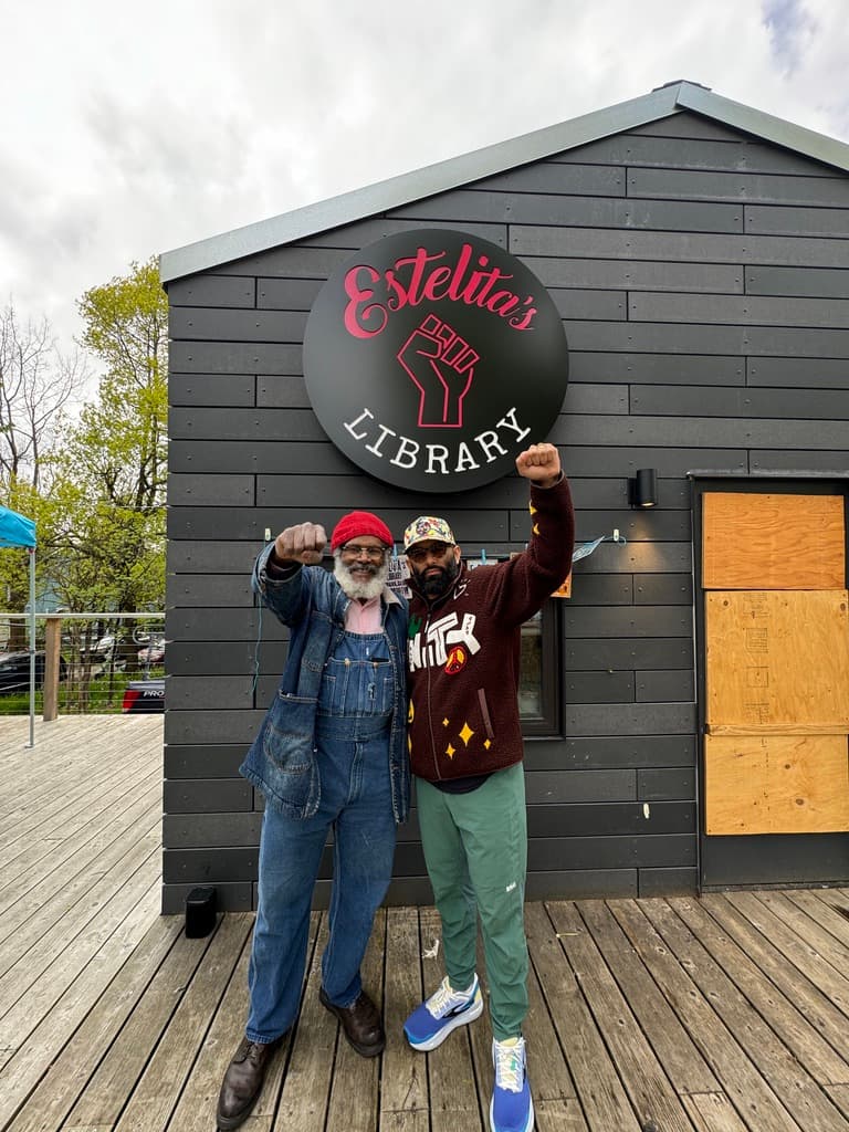 two people at estelita's library exterior sign