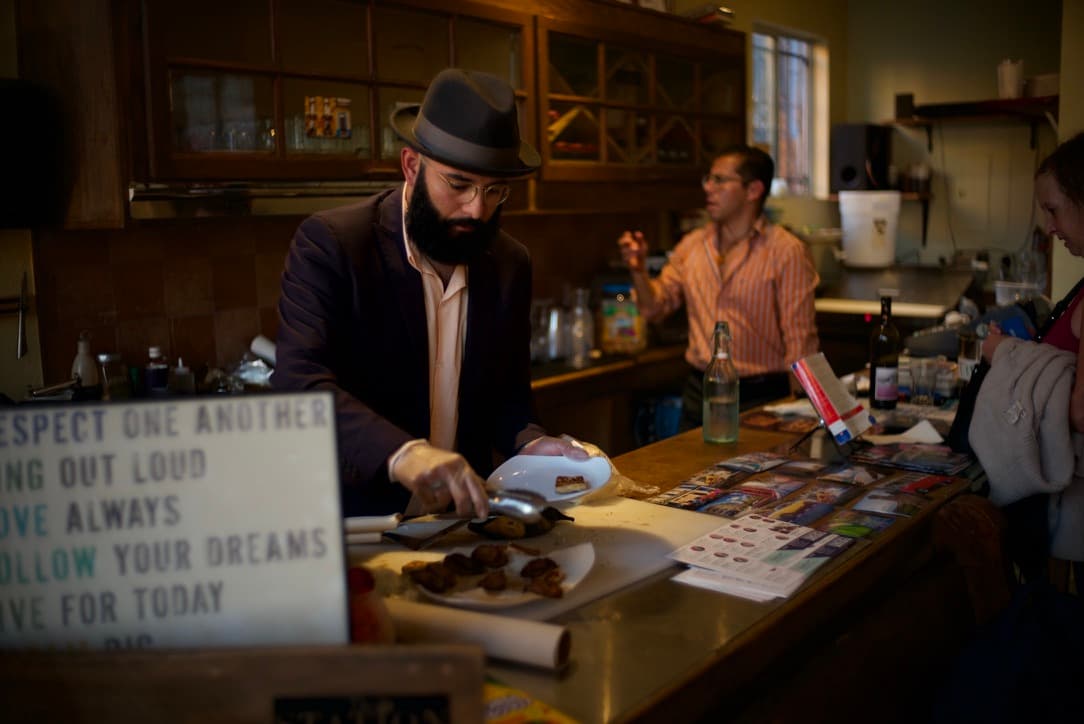 edwin serving at estelita's library counter