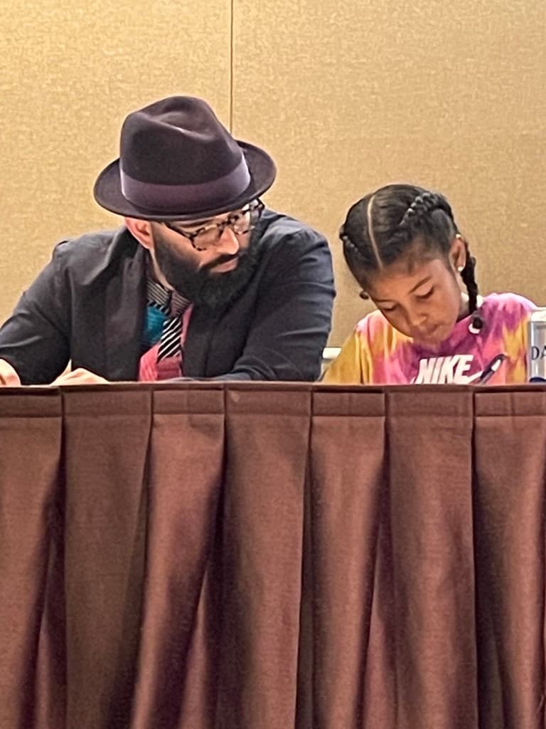 edwin reading and working with a young child